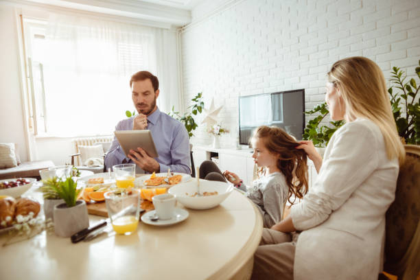 istock Happy young family having breakfast at home 1430554168