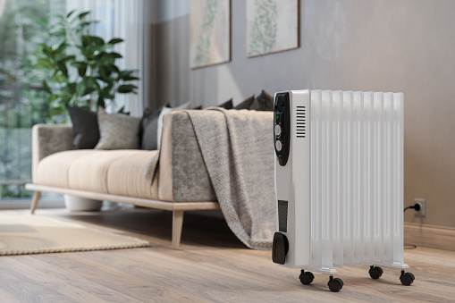 Close-up View Of Electric Radiator Heater In Living Room With Blurred Background