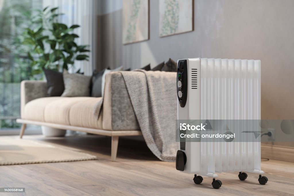 Close-up View Of Electric Radiator Heater In Living Room With Blurred Background Electric Heater Stock Photo
