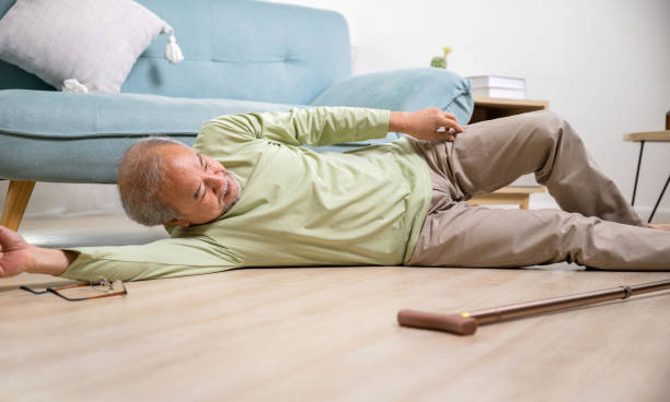 istock Asian old man lying on floor after falling down with wooden walking stick 1430560492