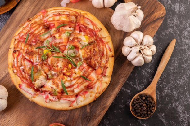 istock pizza placed on a wooden plate. 1430560800