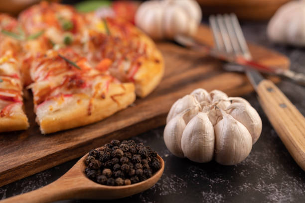 pizza placed on a wooden plate.