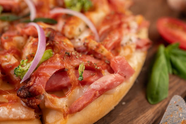 pizza placed on a wooden plate.
