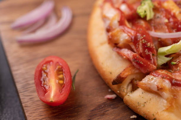 istock pizza placed on a wooden plate. 1430563140