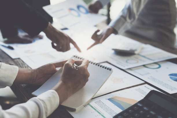 istock Asian Businessman working to analyze technical price graph and indicator with business team 1430564044