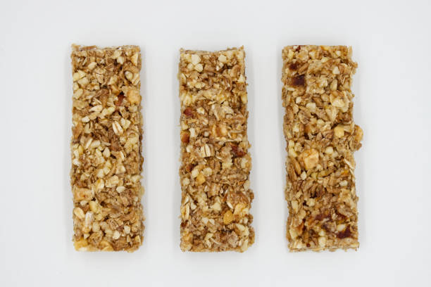 Cereal bar with apricot, apple and dried fruit on white background stock photo