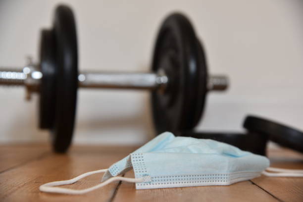 istock a dumbbell on the ground and a mask 1430571640