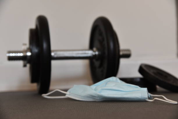 istock a dumbbell on the ground and a mask 1430571795