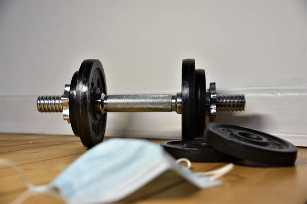 istock a dumbbell on the ground and a mask 1430572003