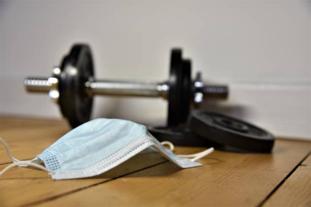 istock a dumbbell on the ground and a mask 1430572242