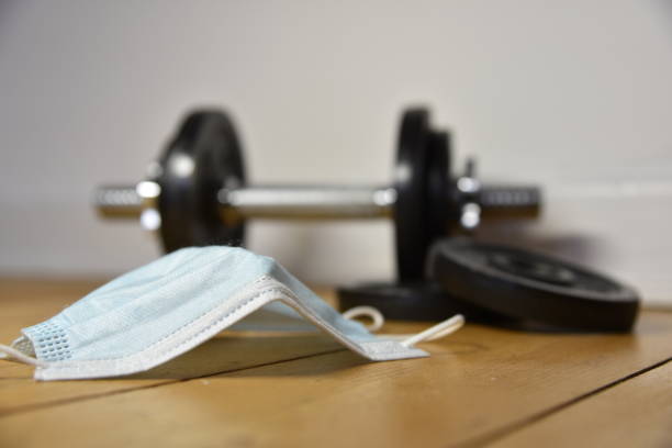 istock a dumbbell on the ground and a mask 1430572613