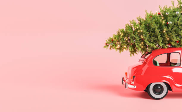 istock Vintage car with decorated Xmas tree on hood in pink studio 1430573065