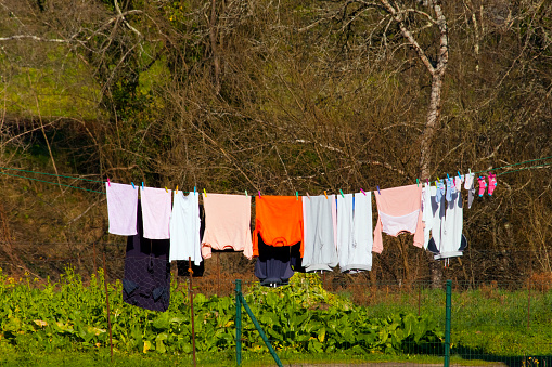 Wet clothes drying in the sun. Laundry  hanging in back yard. Galicia, Spain.