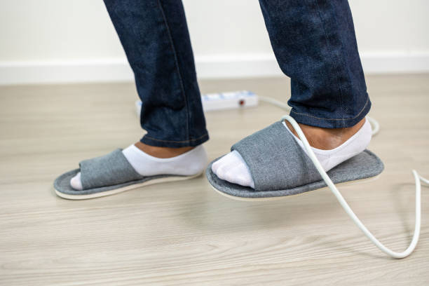istock A man stumbles upon a cluttered wire lying on the ground. Stumbled until the head hit the ground. Accident at home It is because of carelessness and clumsiness electric shock 1430579406