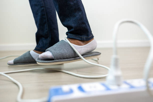 istock A man stumbles upon a cluttered wire lying on the ground. Stumbled until the head hit the ground. Accident at home It is because of carelessness and clumsiness electric shock 1430579421
