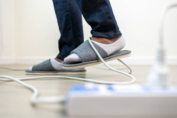 istock A man stumbles upon a cluttered wire lying on the ground. Stumbled until the head hit the ground. Accident at home It is because of carelessness and clumsiness electric shock 1430579606