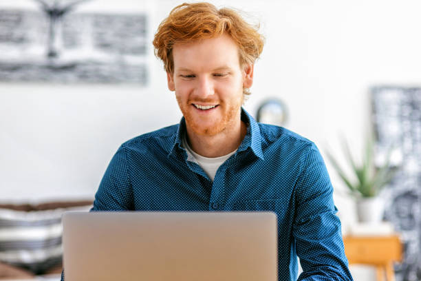 istock Happy businessman or freelancer working from modern office or at home using laptop 1430580560