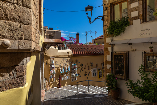 Chania, Crete, Greece - August 26, 2022: Narrow alleys in the old town of Chania with small boutiques, cafes and boutique hotels.