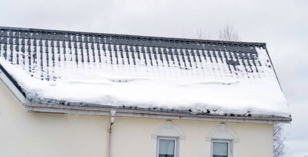 istock Metal Downpipe system, Guttering System, External downpipes and drainage pipes under snow. Corner of house with roof made of gray metal tiles and gutter covered with thick layer of snow in winter. 1430586381