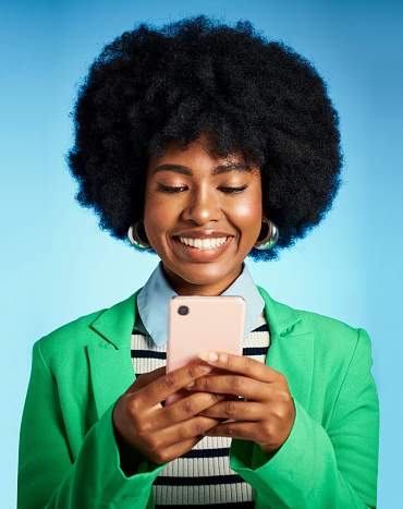 Social media phone, happy email and black woman with smile for communication on web, reading notification and excited about work against blue studio background. African influencer working on tech