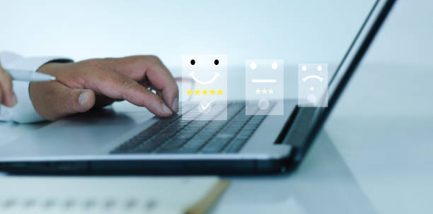 istock Businessman use laptop pressing smiley face emoticon on virtual touch screen. Assessment Survey Experience feedback business quality, service, compliments best.Customer service evaluation concept. 1430595641