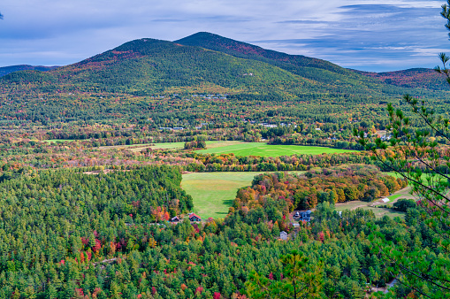 Fall Foliage across the rolling hills of Vermont. Peak fall color on a beautiful sunny day in New England.