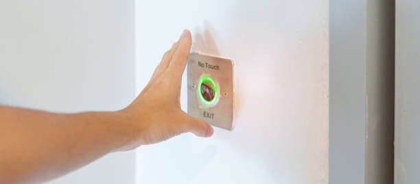 istock Hand open the door by No touch sensor switch on the wall at office or apartment. Contactless, modern, Technology and safety concept 1430597098