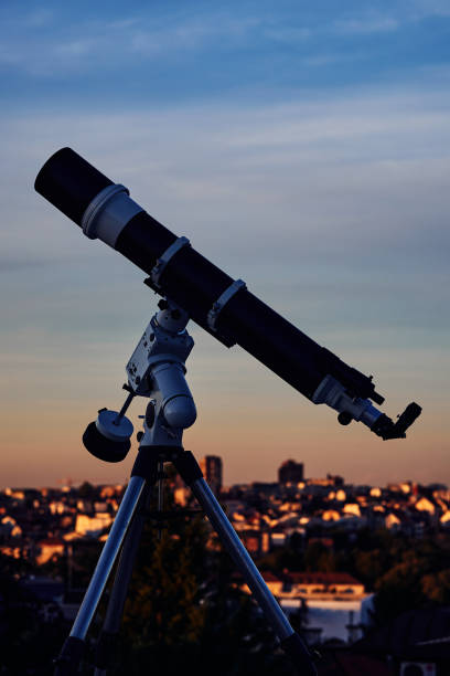 istock Big astronomical telescope under a twilight sky ready for stargazing. 1430597467