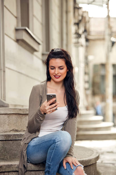 istock Young cute female using smartphone on the street. 1430599259