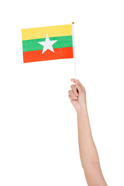 istock Human hand holding Myanmar national flag 1430599681