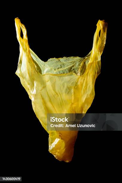 The Head Of An Animal A Horse Or A Cow Made Of A Yellow Plastic Bag On A Dark Background Problem Of Plastic Waste Pollution Microplastics Creative Minimal Concept Contemporary Surreal Art Stock Photo - Download Image Now