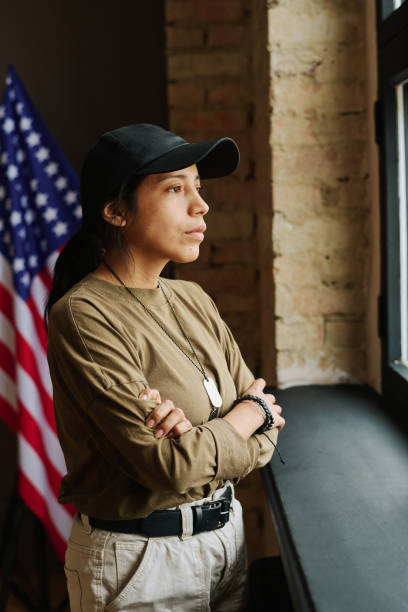 istock Young lonely Hispanic woman with post traumatic syndrome looking through window 1430601043