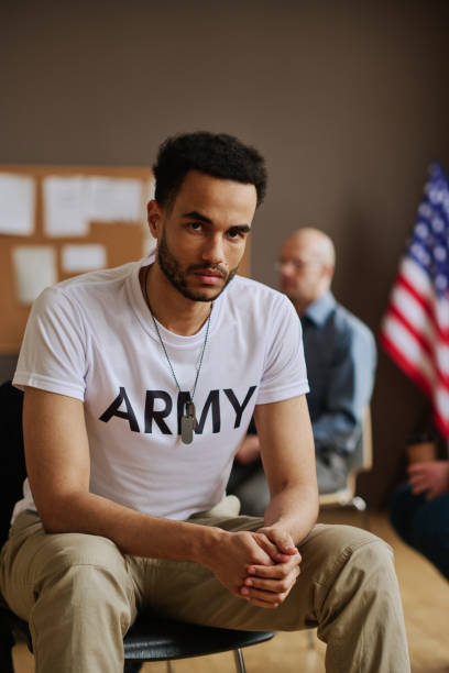 istock Young unhappy man with post traumatic syndrome sitting against counselor 1430601047