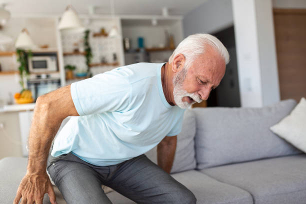 istock Senior elderly man touching his back, suffering from backpain, sciatica, sedentary lifestyle concept. Spine health problems. Healthcare, insurance 1430608791