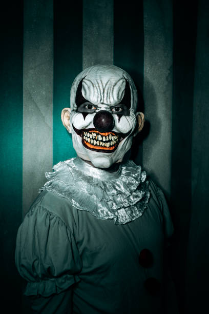istock creepy evil clown stands in the old circus 1430609562