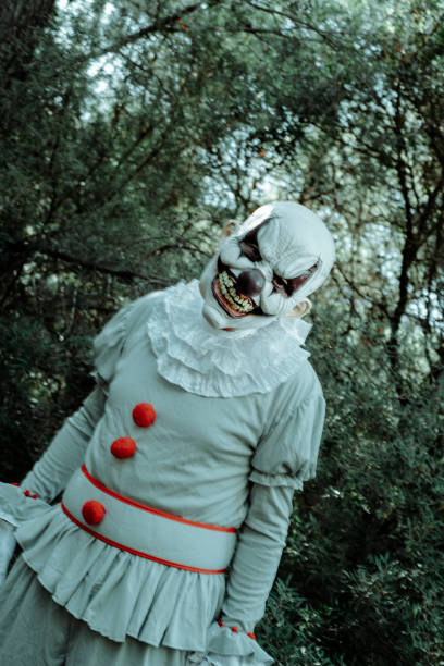 istock blurred evil clown in motion in the woods 1430610211
