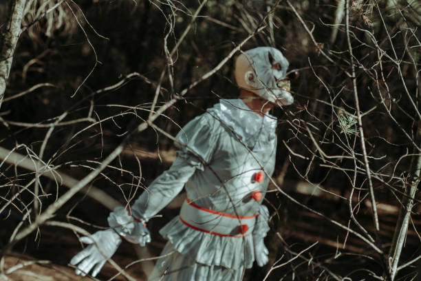 istock scary evil clown in the woods at dusk 1430610483