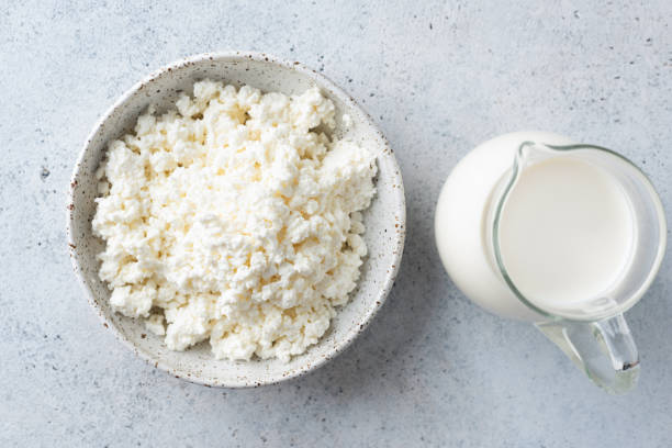 Cottage cheese and milk Cottage cheese, farmers cheese and jar of cow's milk. Dairy products, top view curd cheese stock pictures, royalty-free photos & images