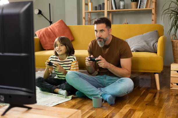 istock Father and son gaming at home 1430616781