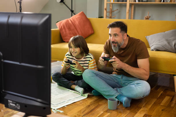 istock Man and his little boy gaming and having fun 1430616792