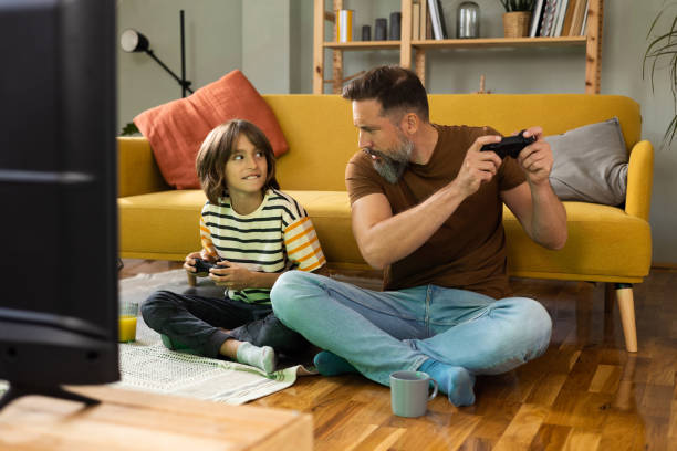 istock Man and his son competing in gaming at home 1430616800