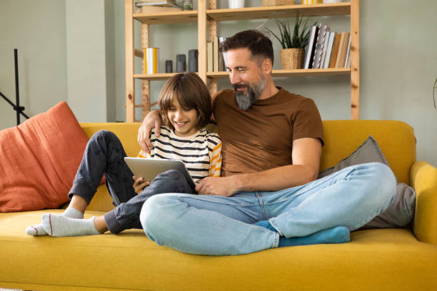 istock Father and son enjoying together and using a digital tablet 1430616806