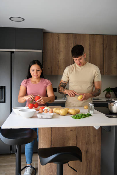 istock Two young latin people cooking together. 1430617842