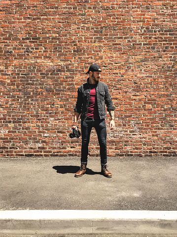 casual photographer against the wall
