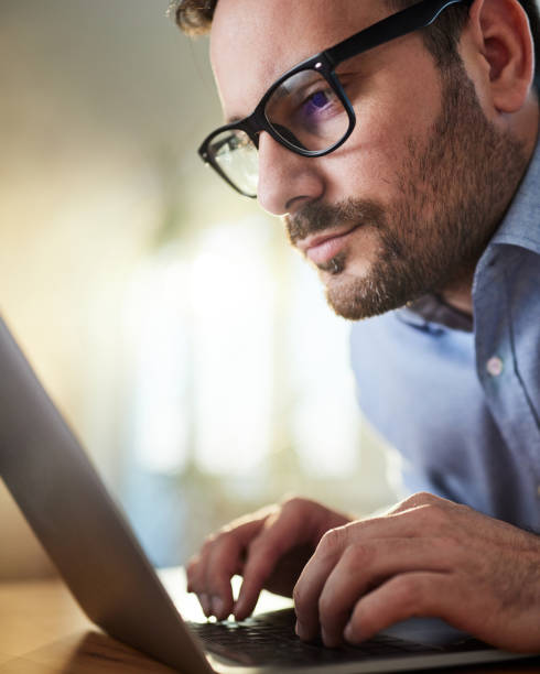 istock Young businessman typing an e-mail on laptop in the office. 1430623629