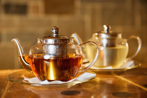 istock Transparent glass teapots for tea with black and white tea on the cafe table 1430625616