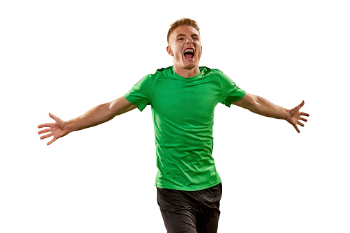 Goal. Excited football player shouting, expressing win emotions isolated over white background. Sport, win, victory, champion and success concept. Copy space for ad