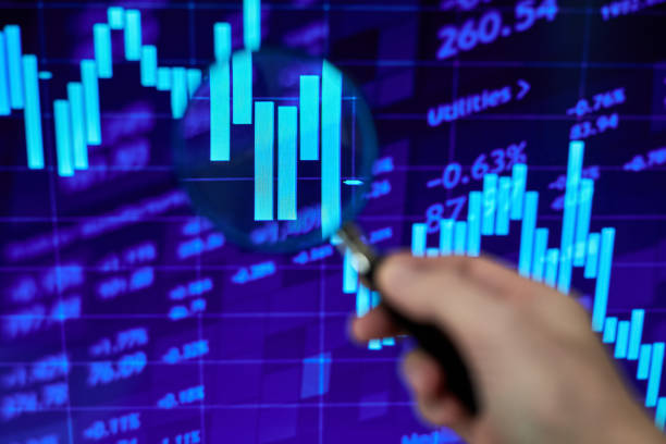 istock A trader looking at a stock market chart through a magnifying glass 1430625982