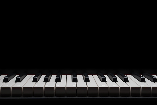 Electric piano keyboard on a black background for advertising