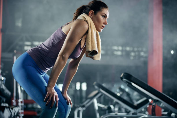 istock Young athletic woman taking a break in a gym. 1430630055